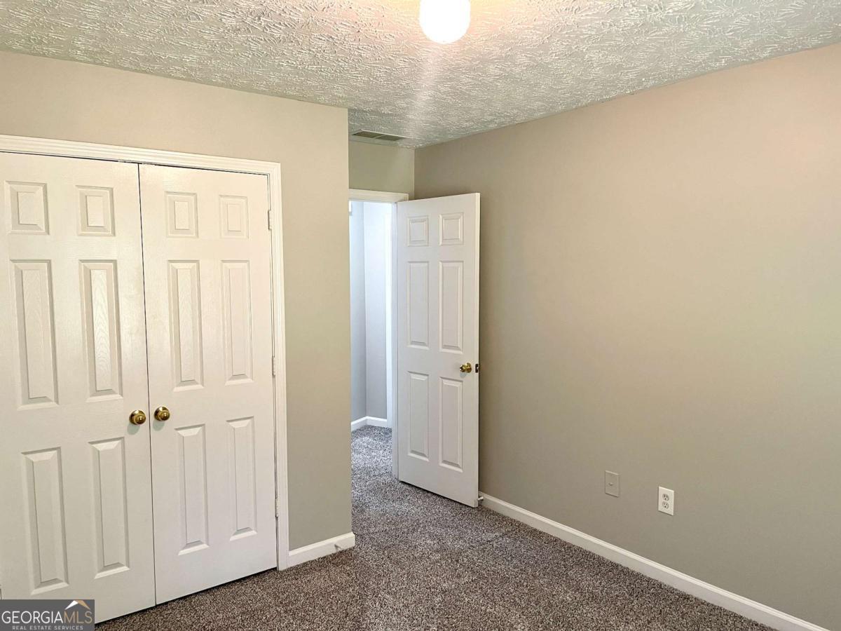 215 Mountain Ridge Covington, GA 30016 - Photo 14 of 23 an empty room with windows