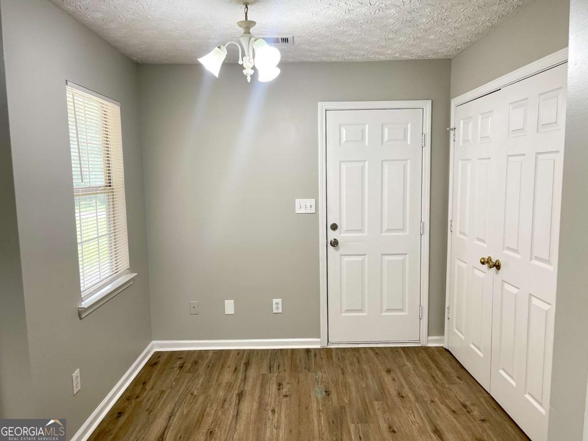 215 Mountain Ridge Covington, GA 30016 - Photo 15 of 23 wooden floor in an empty room with a window