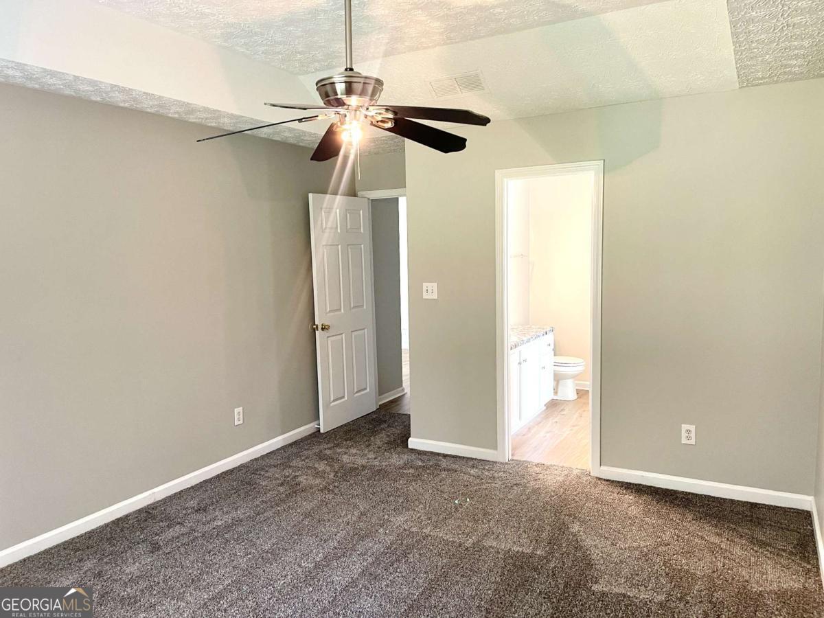 215 Mountain Ridge Covington, GA 30016 - Photo 18 of 23 a view of a room and a chandelier fan