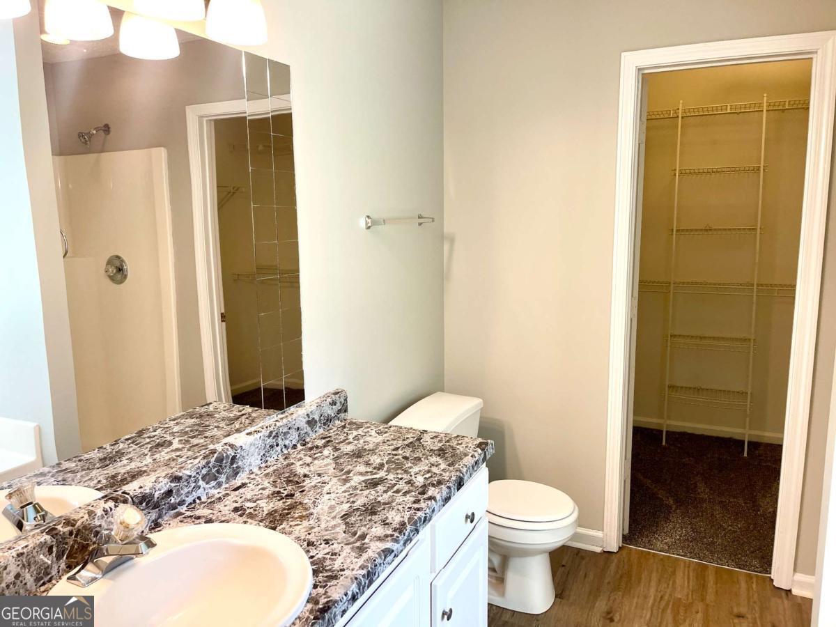 215 Mountain Ridge Covington, GA 30016 - Photo 19 of 23 a bathroom with a granite countertop sink toilet and shower