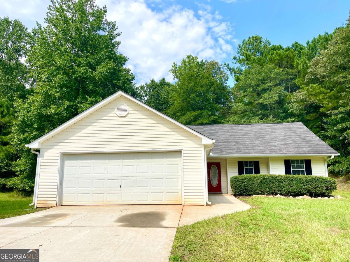 215 Mountain Ridge Covington, GA 30016 - Photo 2 of 23 a front view of a house with a yard and garage