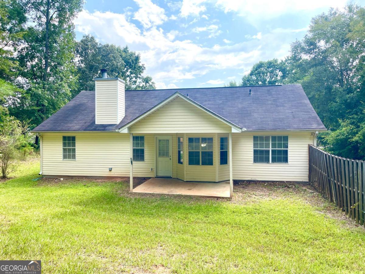 215 Mountain Ridge Covington, GA 30016 - Photo 23 of 23 a front view of a house with a garden and yard