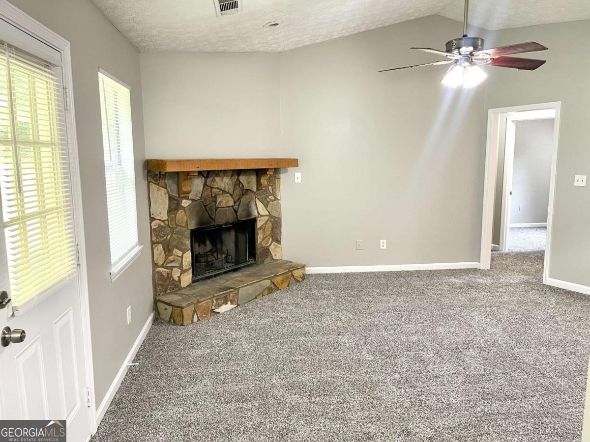 215 Mountain Ridge Covington, GA 30016 - Photo 5 of 23 a view of an empty room with window and fireplace