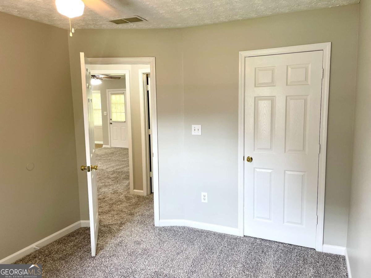 215 Mountain Ridge Covington, GA 30016 - Photo 10 of 23 an empty room with windows