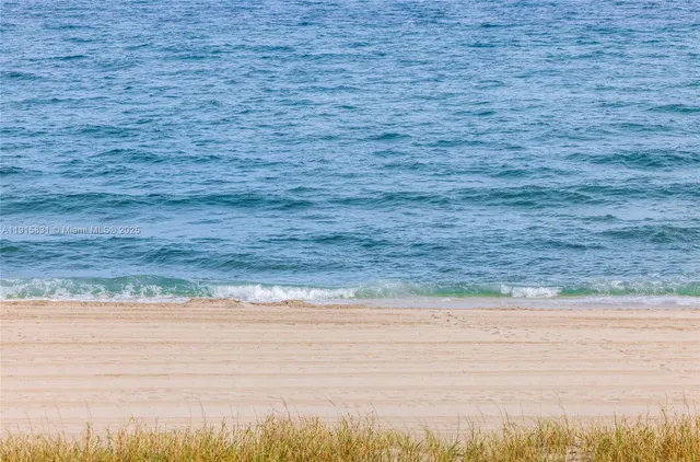 a living room with furniture a flat screen tv and a lamp