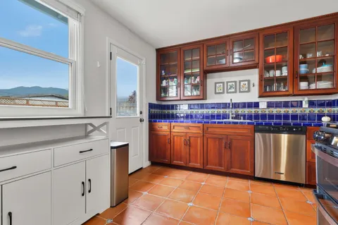 a kitchen with stainless steel appliances granite countertop a sink and cabinets