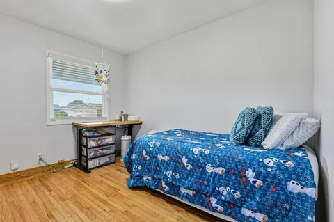 a bedroom with a bed and window