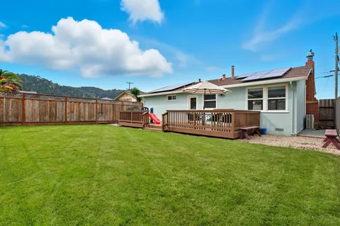 a view of a house with backyard and porch