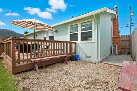 a view of a house with a yard and sitting area