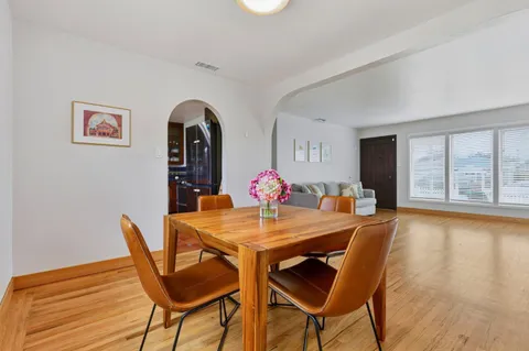 a view of a dining room with furniture and a window