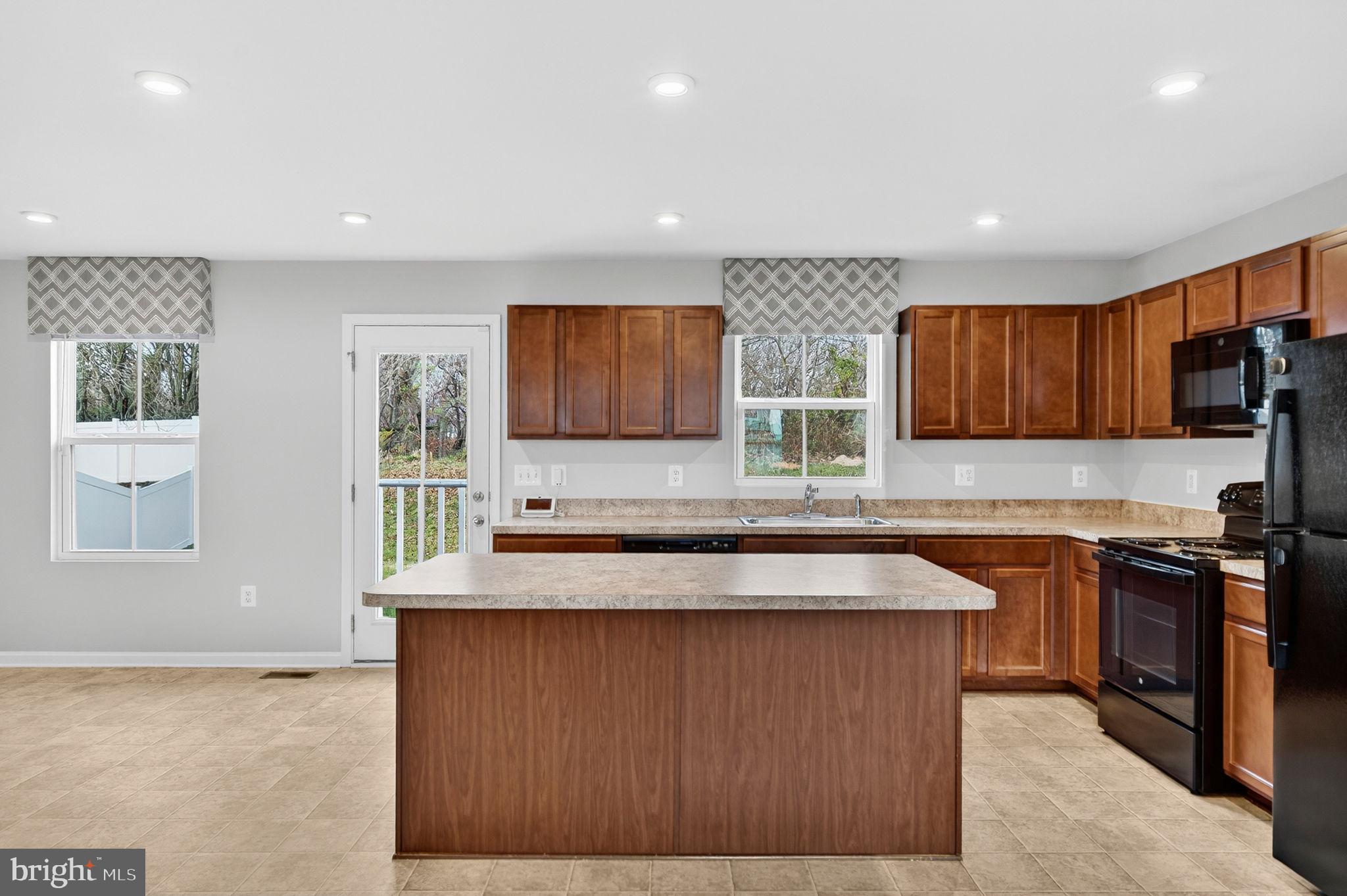 129 Birmingham Drive Middletown, VA 22645 - Photo 19 of 55 a kitchen with stainless steel appliances granite countertop wooden cabinets a stove top oven a sink and dishwasher