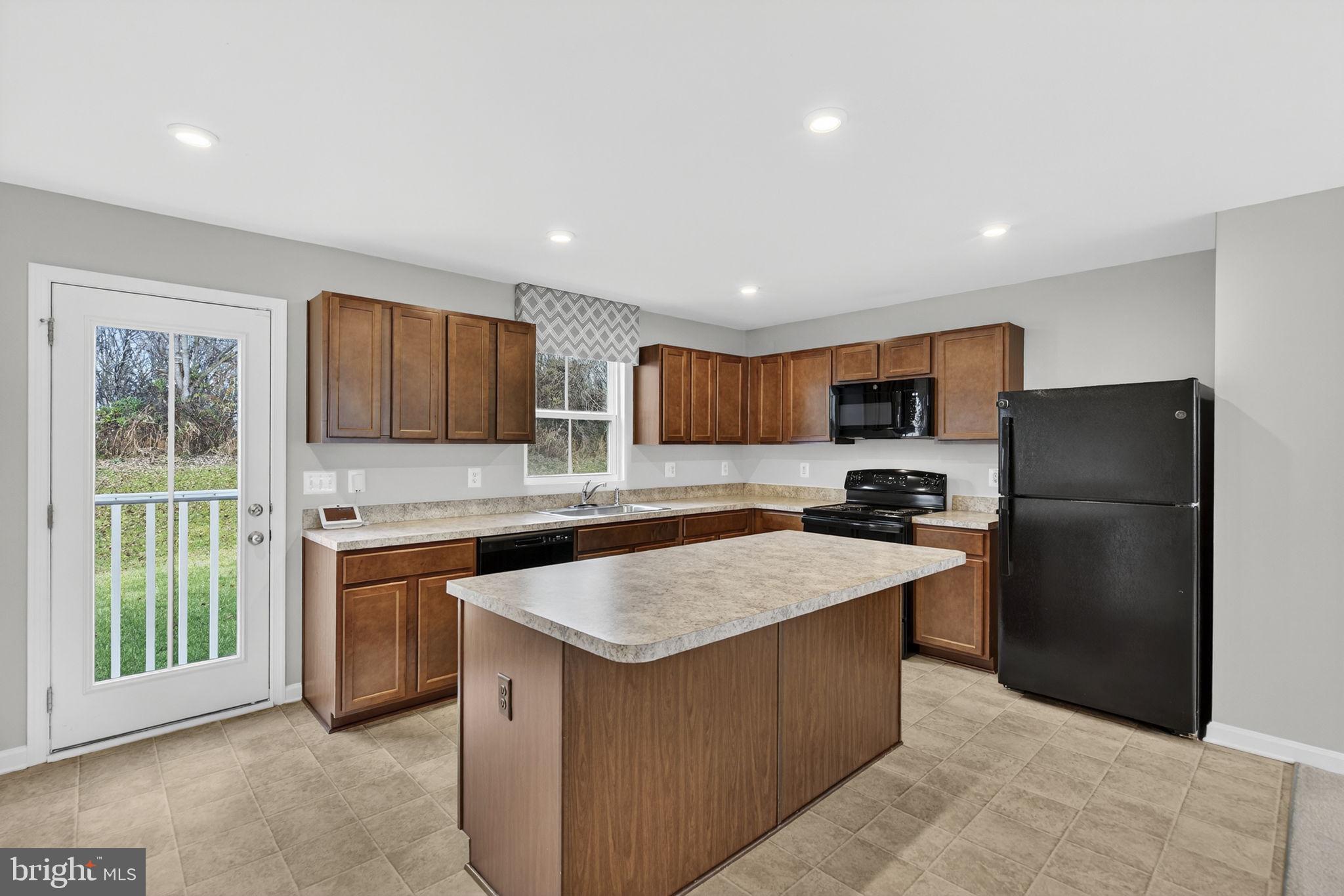 129 Birmingham Drive Middletown, VA 22645 - Photo 20 of 55 a kitchen with stainless steel appliances granite countertop a refrigerator a sink a stove a microwave and island