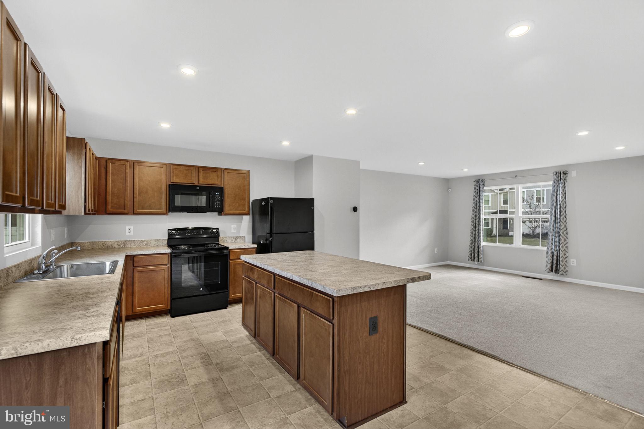 129 Birmingham Drive Middletown, VA 22645 - Photo 21 of 55 a kitchen with stainless steel appliances granite countertop a sink dishwasher stove top oven and refrigerator