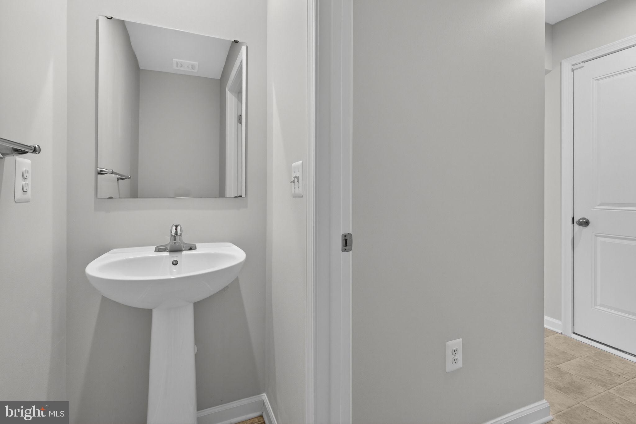 129 Birmingham Drive Middletown, VA 22645 - Photo 27 of 55 a bathroom with a sink and a mirror