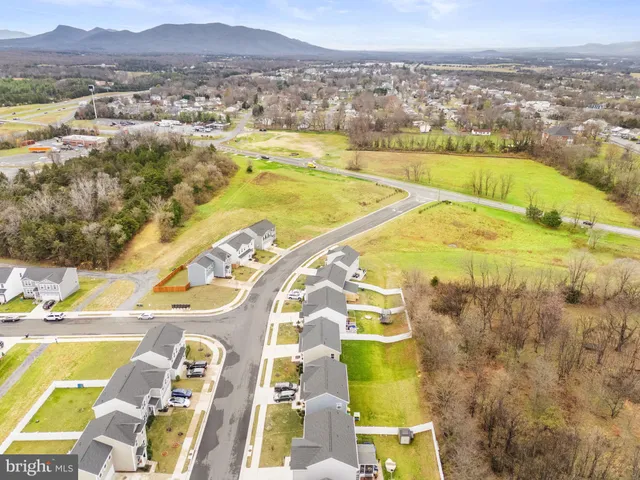 an aerial view of residential houses with outdoor space and swimming pool