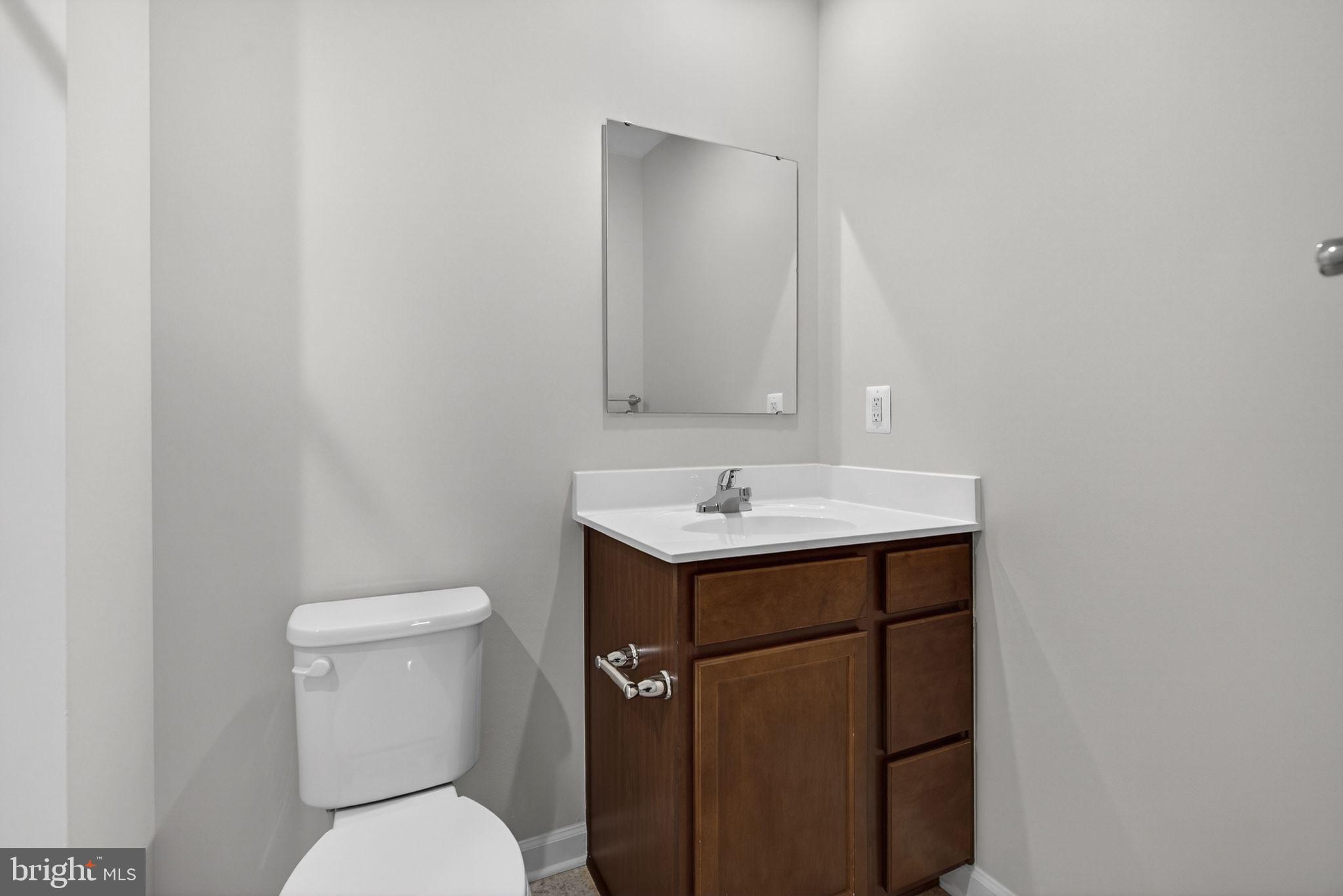 129 Birmingham Drive Middletown, VA 22645 - Photo 35 of 55 a bathroom with a sink toilet and mirror
