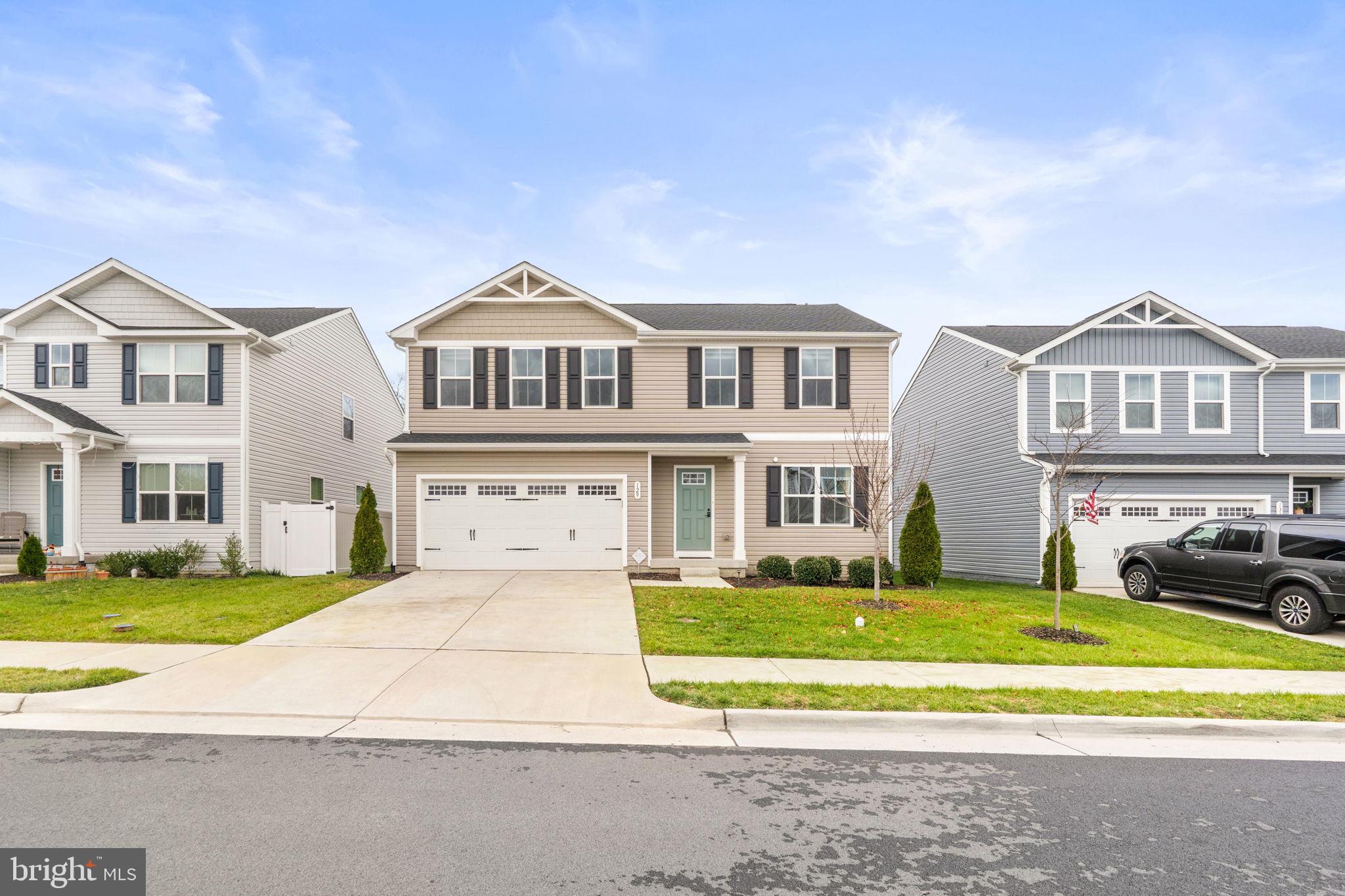 129 Birmingham Drive Middletown, VA 22645 - Photo 7 of 55 a front view of a house with a garden and trees