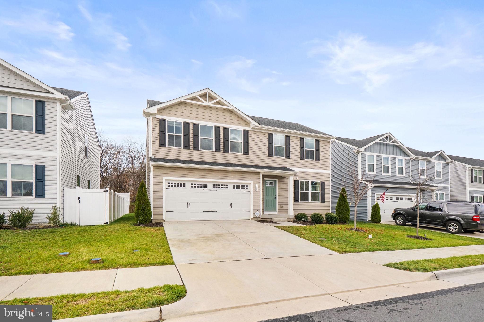 129 Birmingham Drive Middletown, VA 22645 - Photo 8 of 55 a front view of a house with a yard and garage
