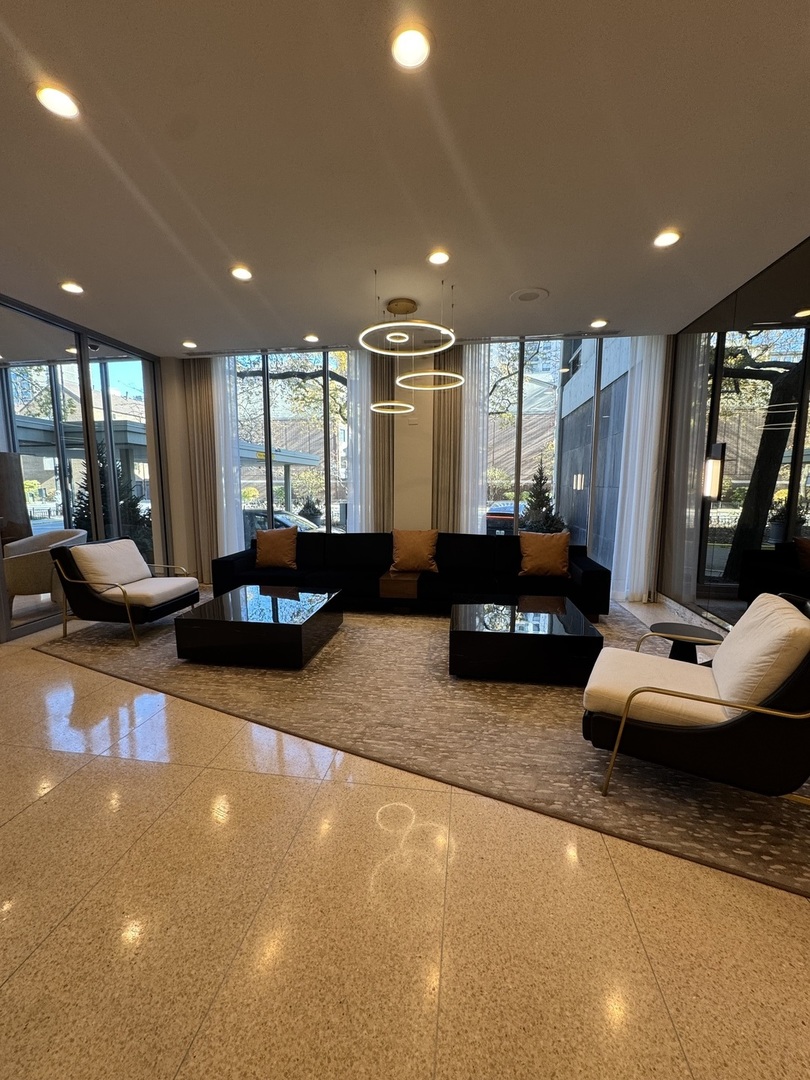 1255 North Sandburg Terrace, Unit 305 Chicago, IL 60610 - Photo 16 of 16 a living room with furniture a large window and gym equipment