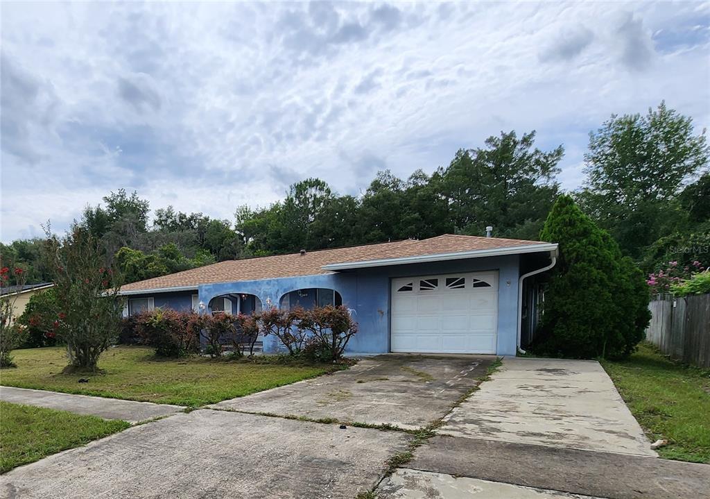 14526 Southwest 43rd Court Road Ocala, FL 34473 - Photo 1 of 1 a front view of a house with a yard and garage