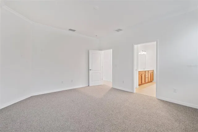 a view of a big room with windows and chandelier fan