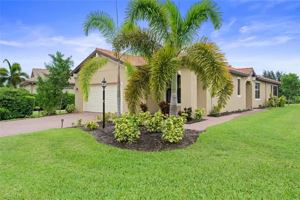 a front view of house with yard and green space