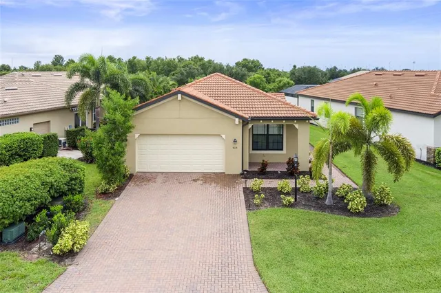 an aerial view of residential house with outdoor space and trees all around