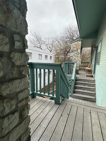 a view of a balcony with wooden floor