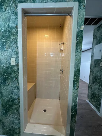 a bathroom with a glass shower door