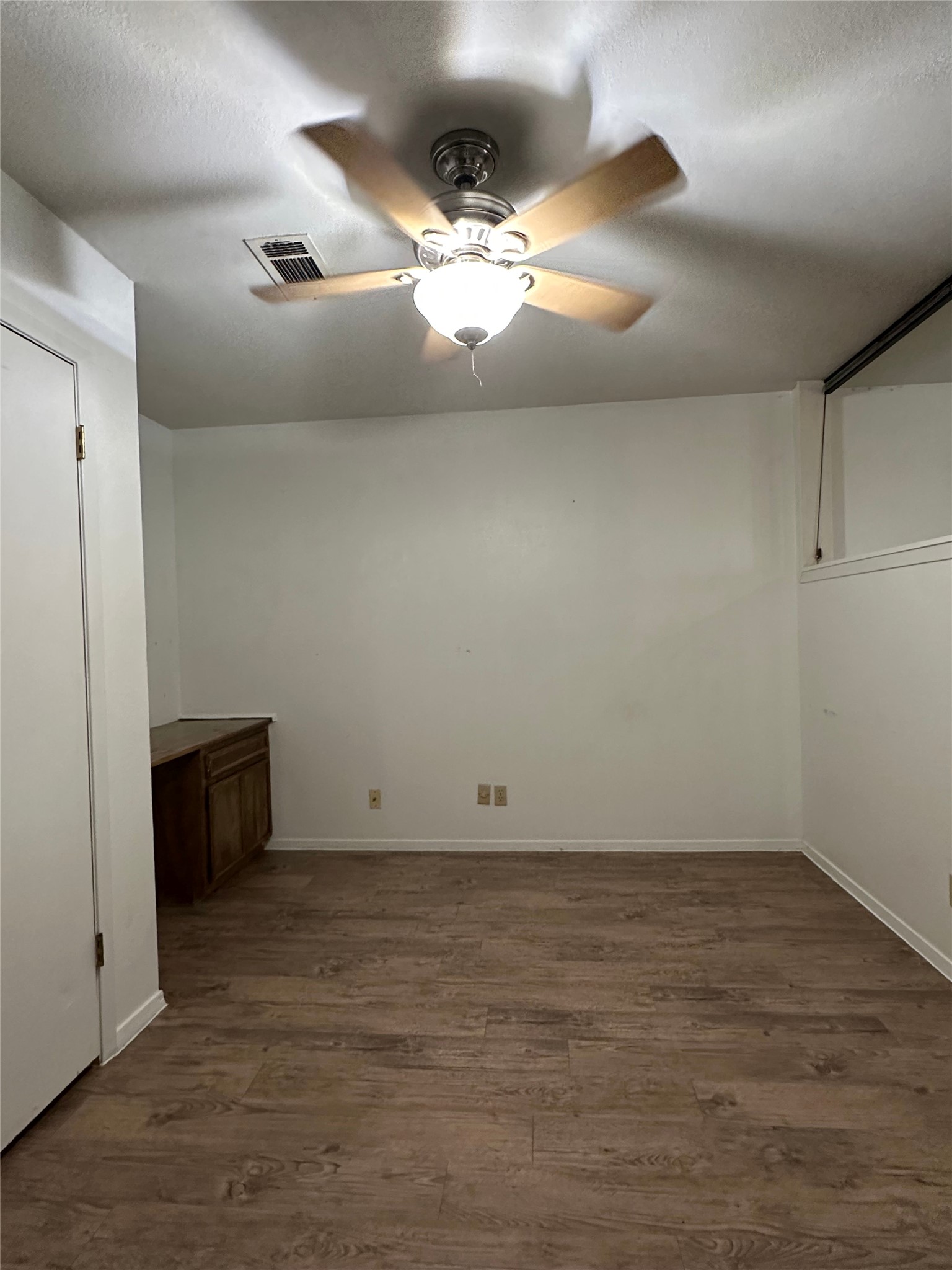 2813 1/2 Rio Grande Street, Unit 7 Austin, TX 78701 - Photo 7 of 11 wooden floor in an empty room