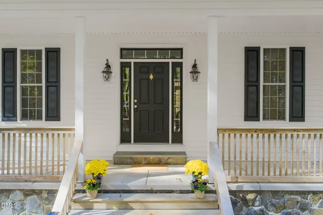 a view of a livingroom with wooden floor and a workspace