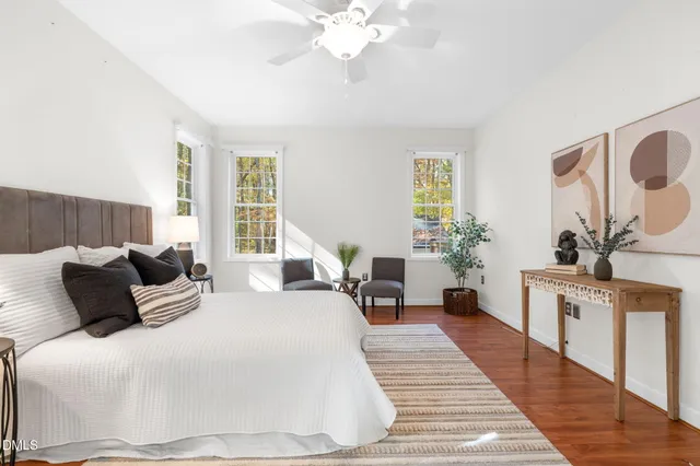 a view of empty room with wooden floor and window