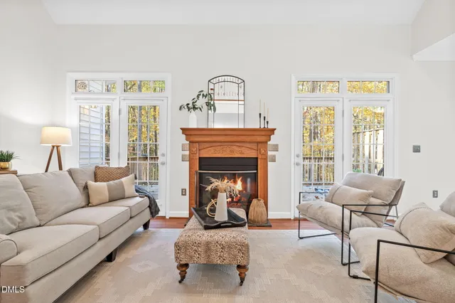a dining room with wooden floor a chandelier a glass table and chairs