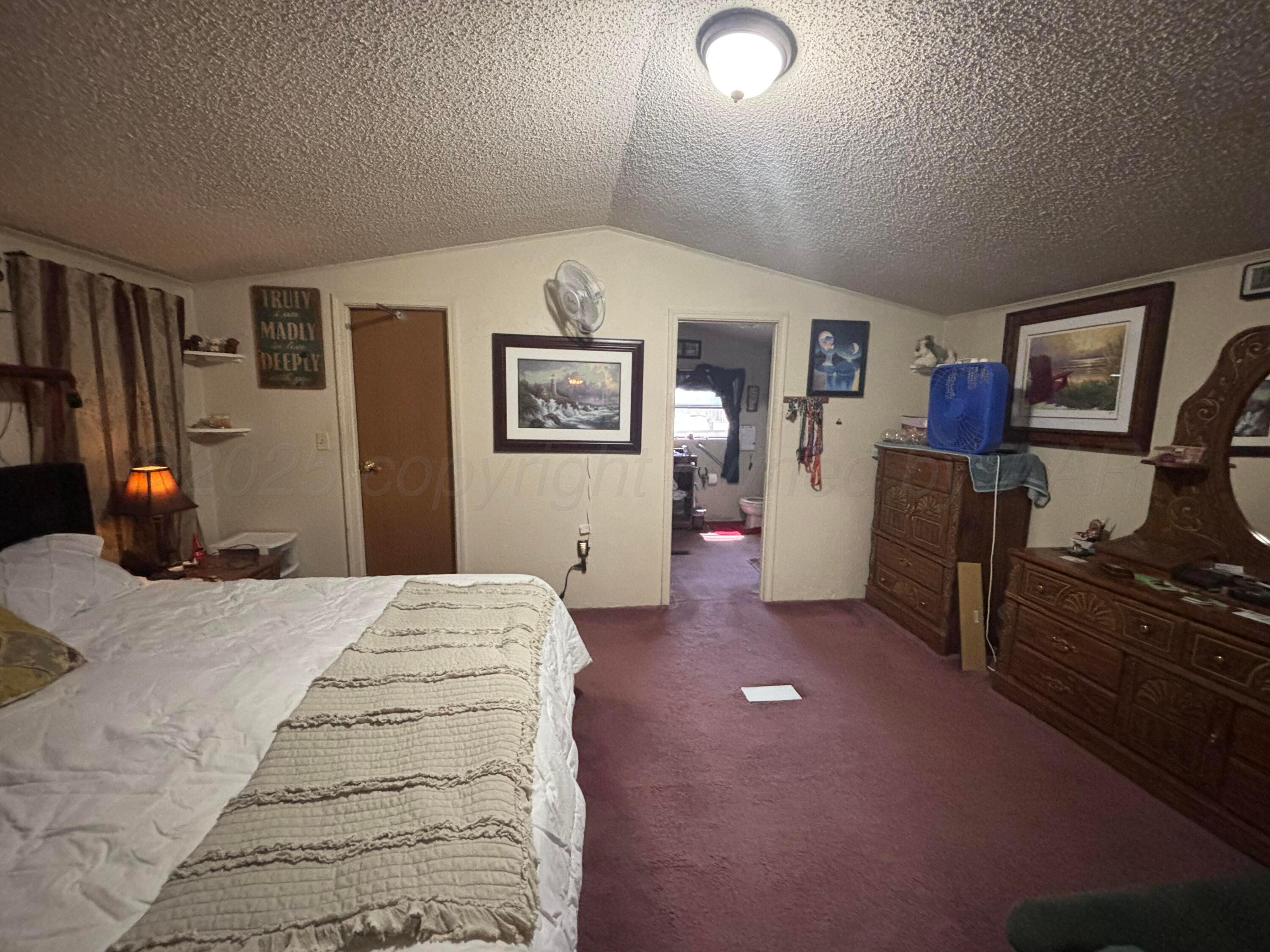 310 County Road KC Childress, TX 79201 - Photo 18 of 25 a bedroom with a bed and wooden floor