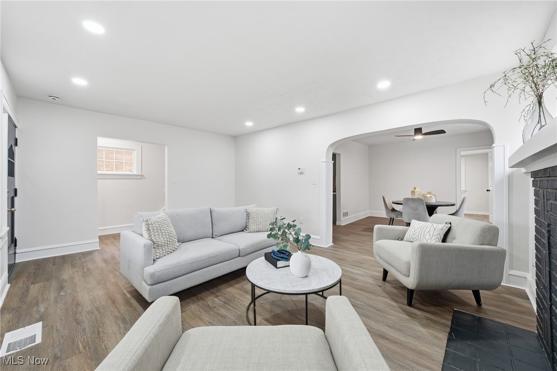 7911 Snow Road Parma, OH 44129 - Photo 7 of 44 Living area featuring arched walkways, wood finished floors, ceiling fan, and recessed lighting