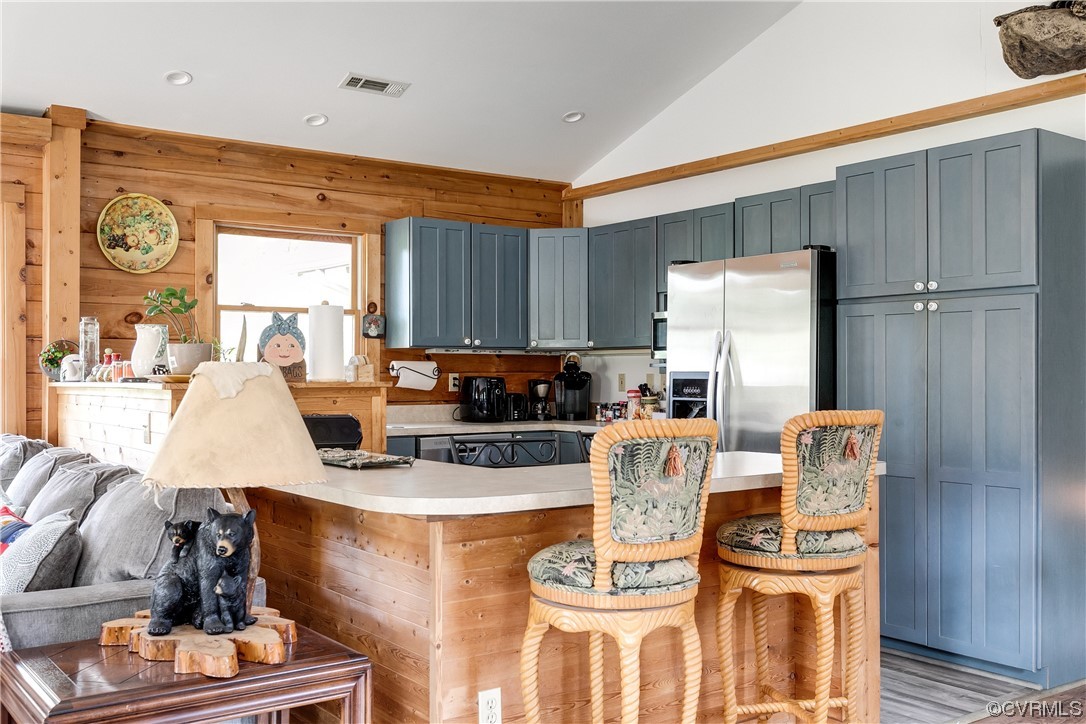 4895 Old Fredericksburg Road Mineral, VA 23117 - Photo 11 of 39 a large kitchen with stainless steel appliances granite countertop a stove a refrigerator a sink a dining table and chairs with wooden floor