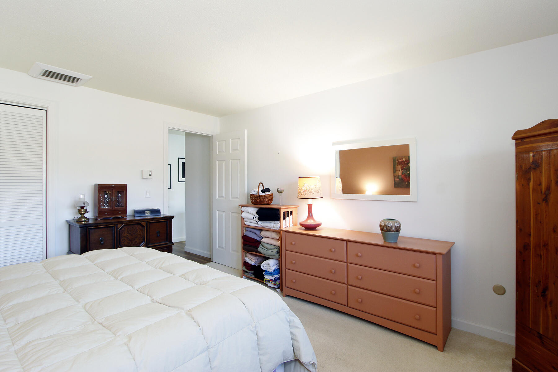 42 Old Colony Way, Unit 6 Orleans, MA 02653 - Photo 15 of 22 a bedroom with a bed and a flat tv screen in it