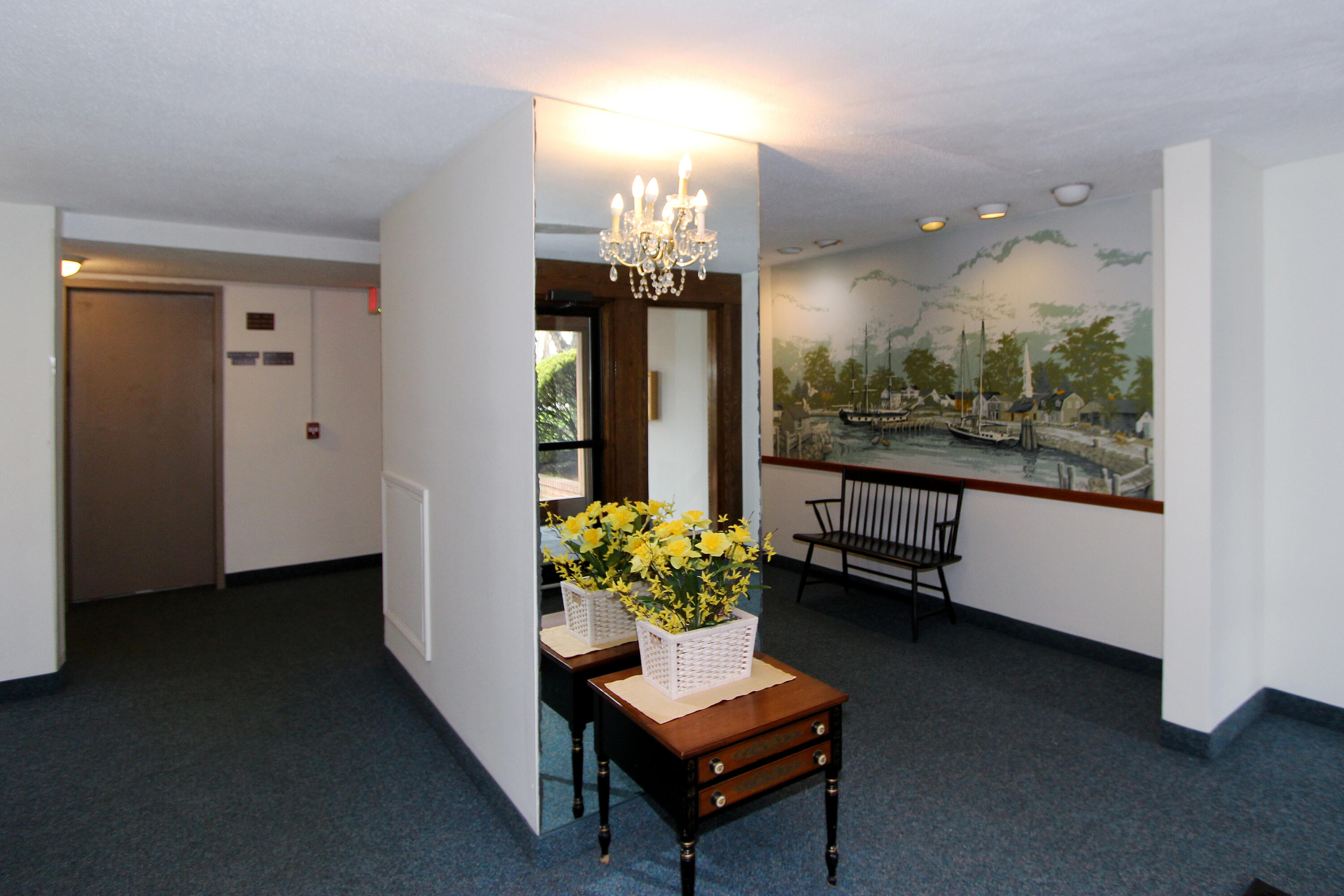 42 Old Colony Way, Unit 6 Orleans, MA 02653 - Photo 20 of 22 a room with furniture and a chandelier