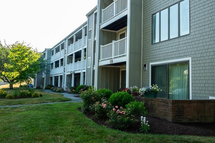 42 Old Colony Way, Unit 6 Orleans, MA 02653 - Photo 2 of 22 a front view of a house with garden and trees