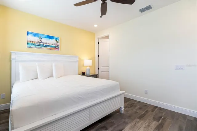 a bedroom with a large bed and a chandelier