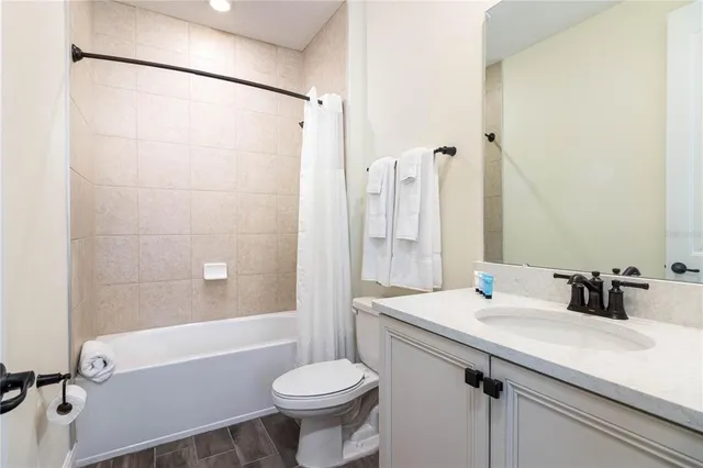 a bathroom with a sink toilet a mirror and shower
