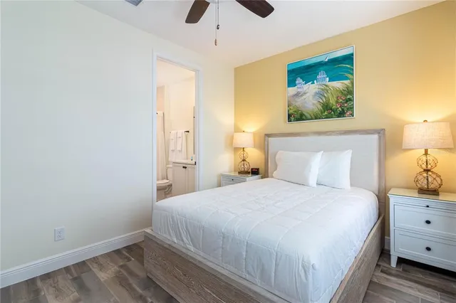 a bedroom with a bed and a painting on the wall