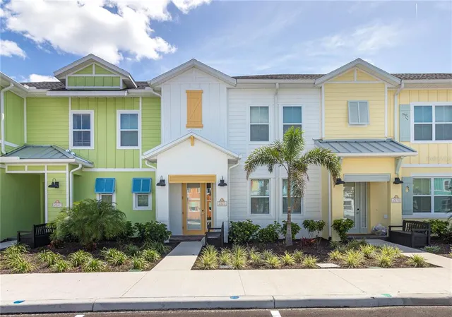 a front view of a residential houses with yard