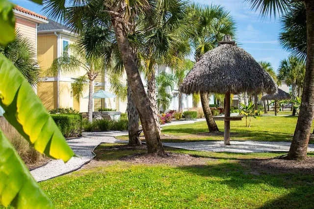 an ocean view with a building and chairs