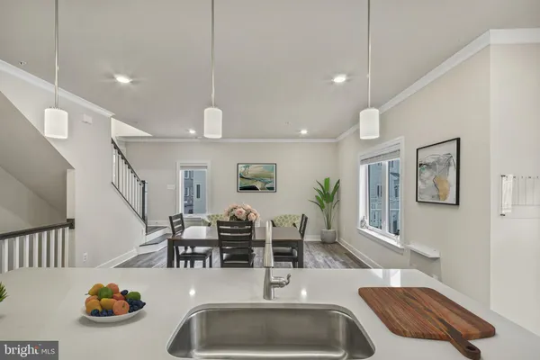 a kitchen with stainless steel appliances kitchen island granite countertop a sink a stove and refrigerator
