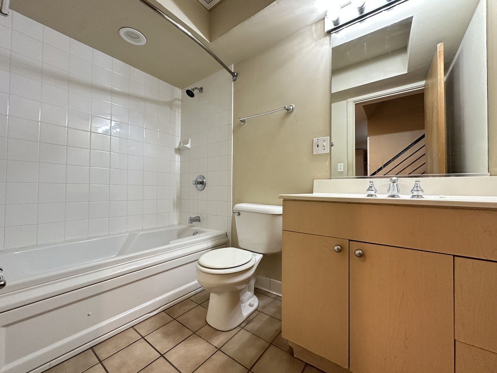933 West Irving Park Road, Unit C Chicago, IL 60613 - Photo 19 of 20 a bathroom with a sink a toilet and shower