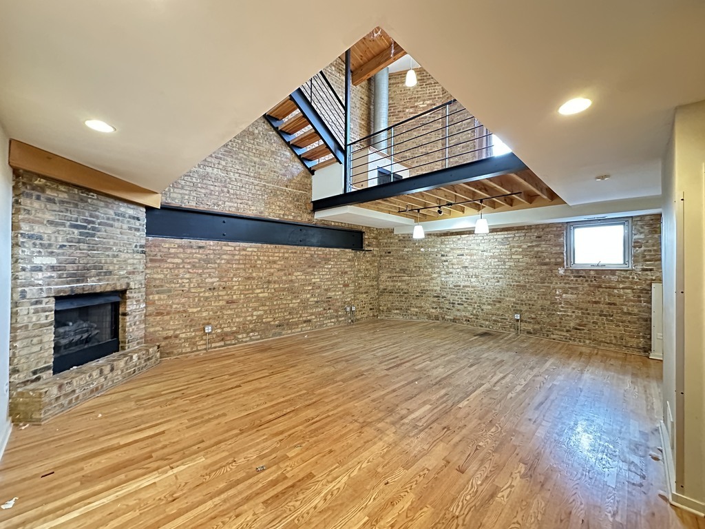 933 West Irving Park Road, Unit C Chicago, IL 60613 - Photo 6 of 20 an outdoor space with wooden floor and a fireplace