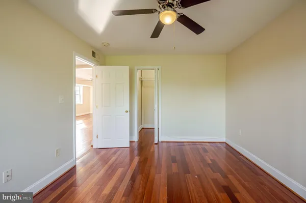 a view of empty room with wooden floor