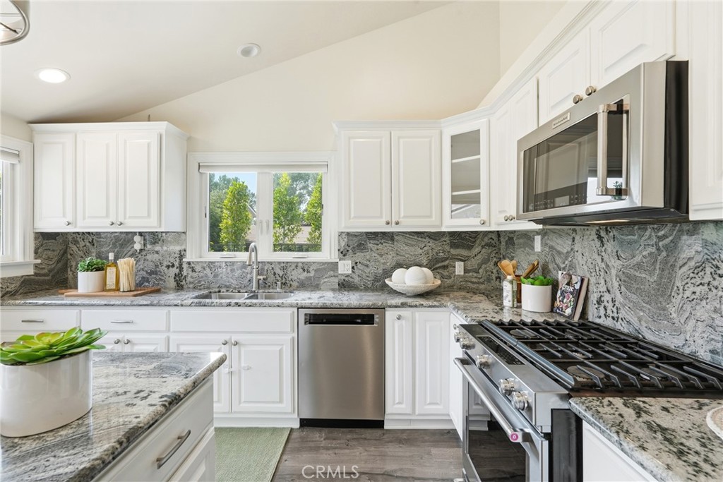 3240 Brace Canyon Road Burbank, CA 91504 - Photo 15 of 39 a kitchen with stainless steel appliances granite countertop a stove a sink and a microwave