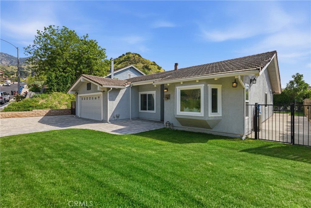 3240 Brace Canyon Road Burbank, CA 91504 - Photo 2 of 39 a front view of a house with a garden